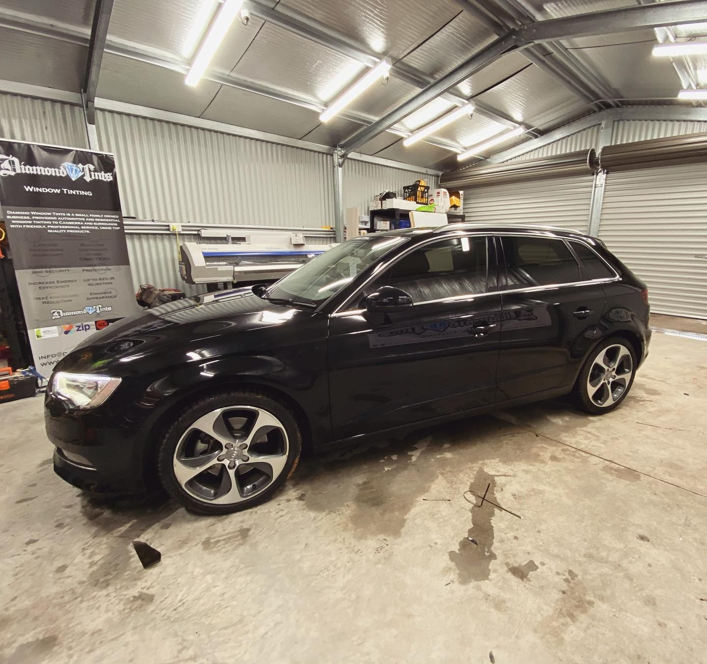 A Black Car is Parked Inside of a Garage — Diamond Tints In Phillip, ACT
