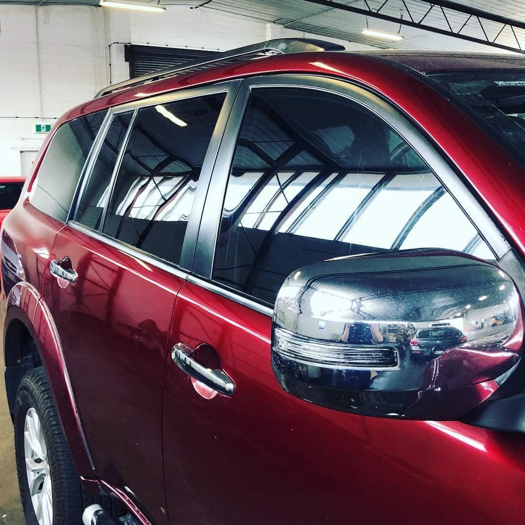 Red Suv with Tinted Windows Parked Indoors, Viewed from The Side — Diamond Window Tints in Phillip, ACT