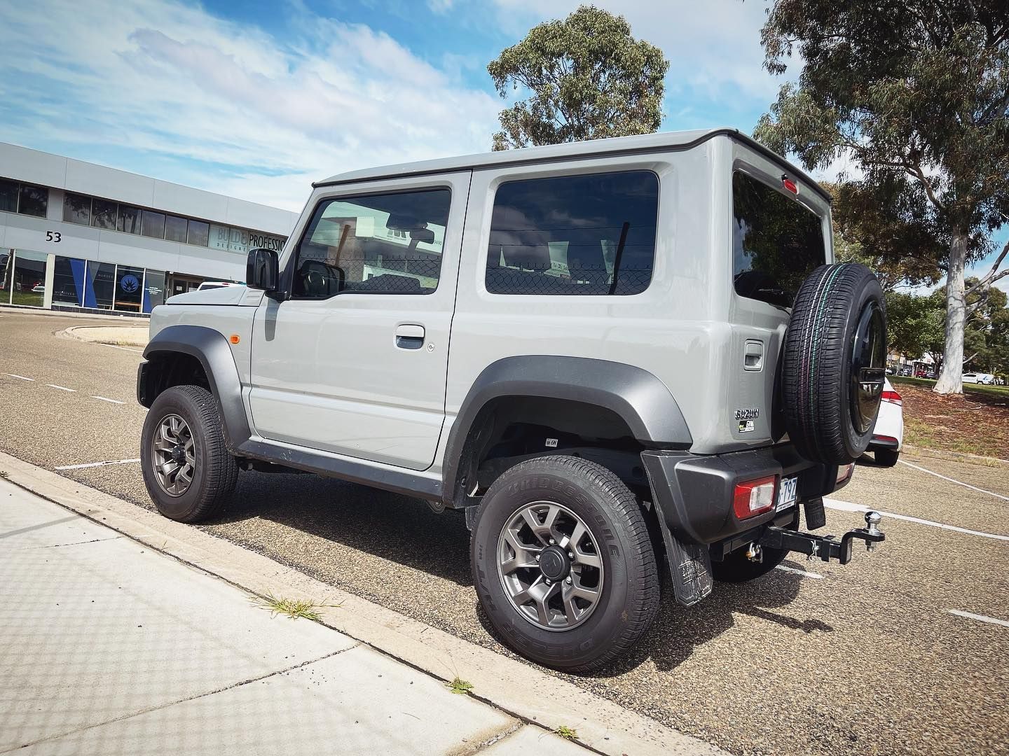 A Gray Suzuki is Parked on the Side of the Road — Diamond Tints In Phillip, ACT