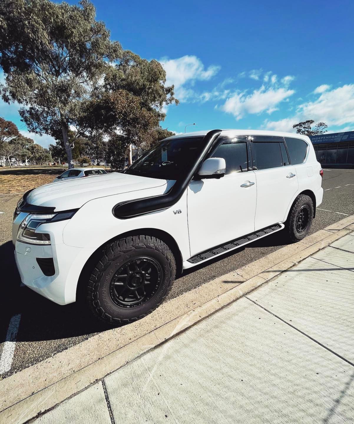 A White SUV With a Snorkel on the Hood is Parked on the Side of the Road — Diamond Tints In Phillip, ACT