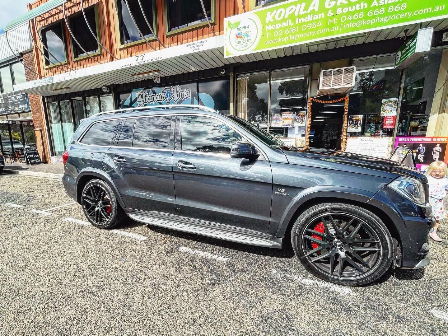 A Mercedes Benz is Parked in Front of a Building — Diamond Tints In Phillip, ACT
