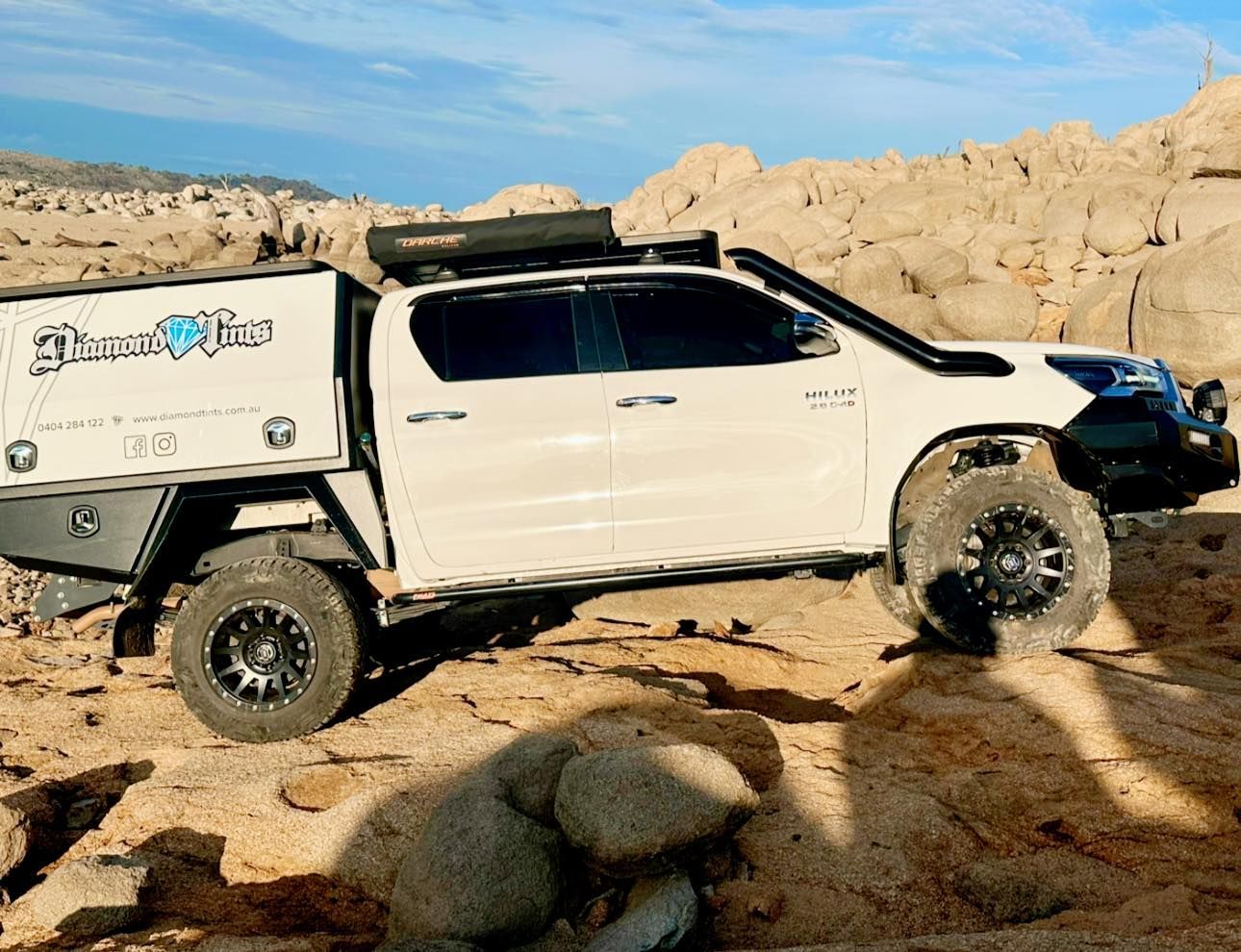 A White Truck With a Canopy is Parked in the Desert — Diamond Tints In Phillip, ACT