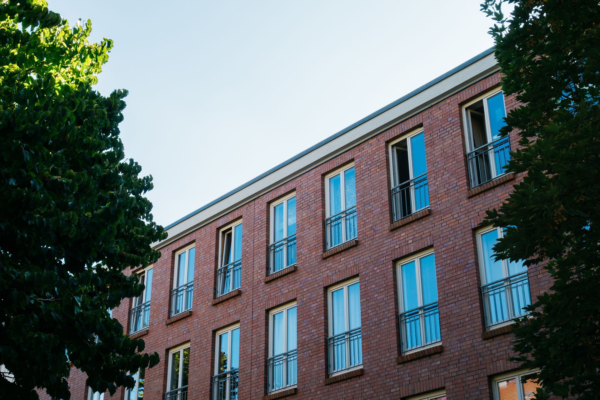 A Large Brick Building With a Lot of Windows and Balconies — Diamond Tints In Goulburn, ACT