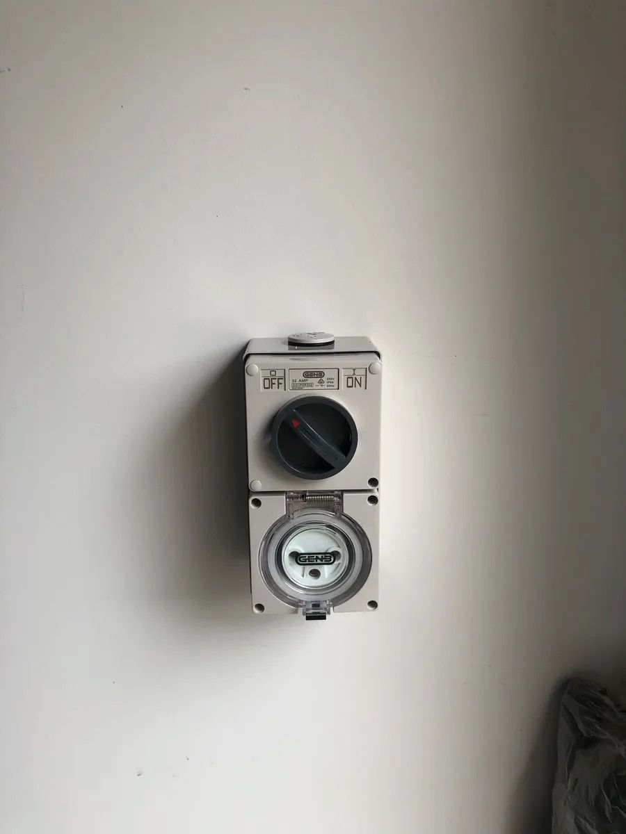 Wall-mounted electrical meter box on a plain white wall. — Technik Electrical in Bowral, NSW