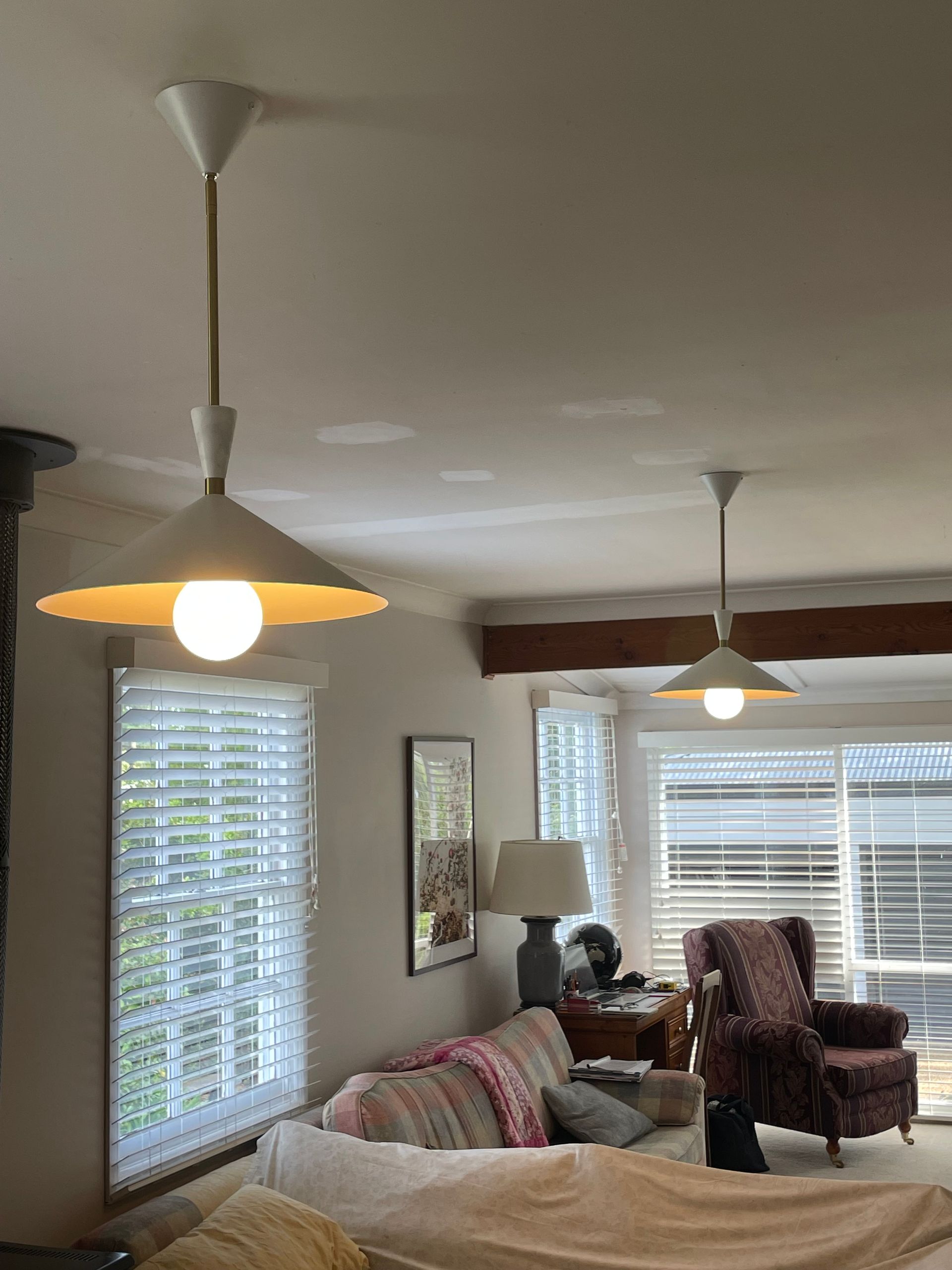 Living room with sofa, recliners, floor lamp, and large windows with blinds and wood valance. — Technik Electrical in Renwick, NSW