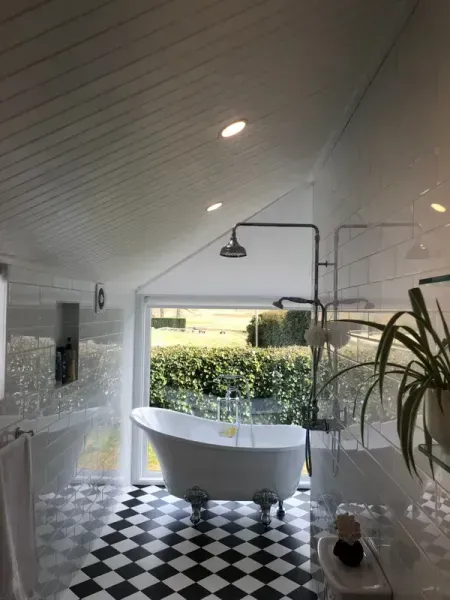 Modern Bathroom With Black-and-white Checkered Floor — Technik Electrical in Renwick, NSW