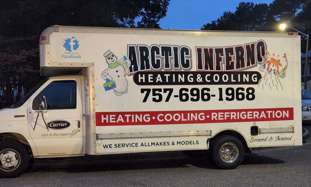 A white Arctic Inferno heating and cooling truck with contact info, parked on a street.