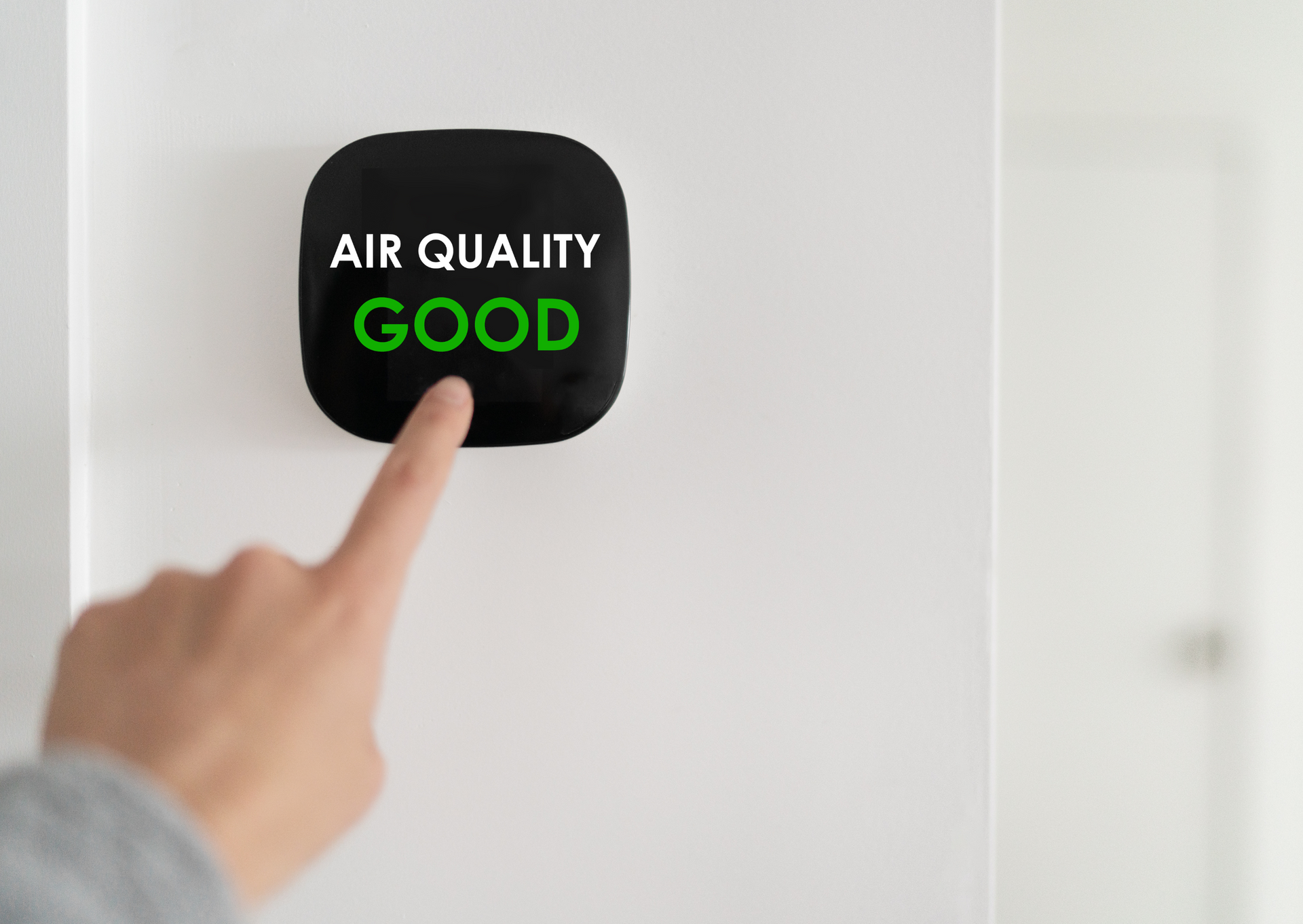 Hand pointing at a black square display showing