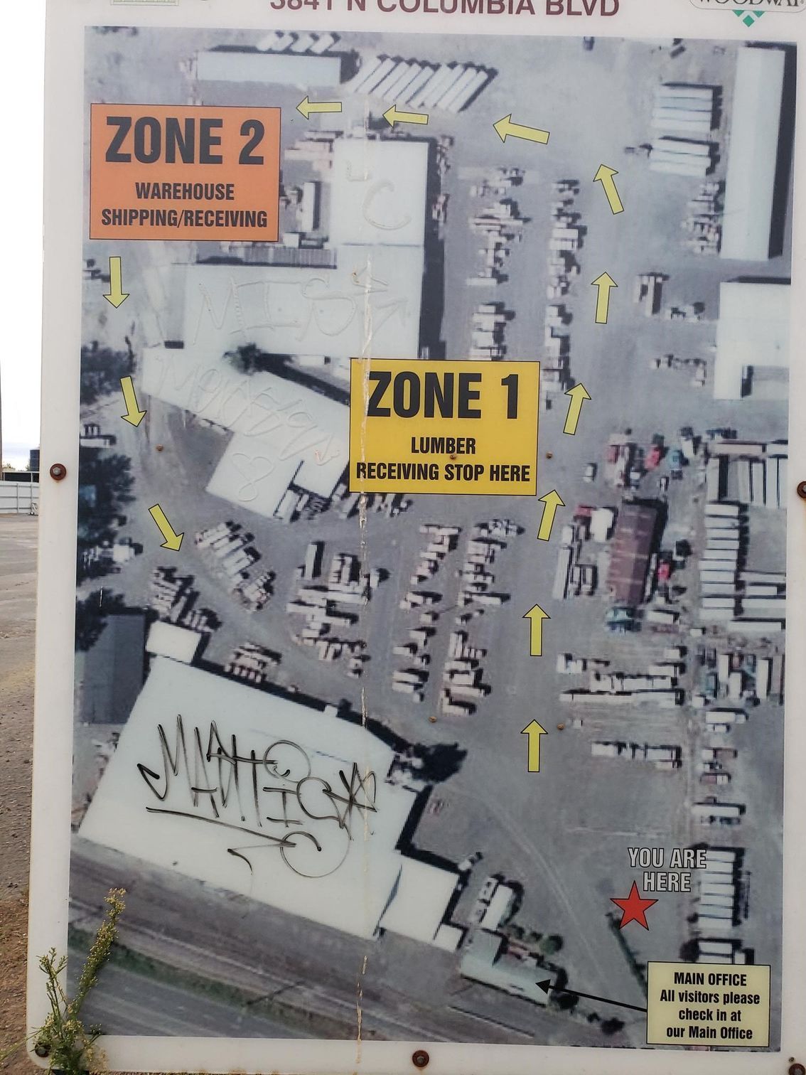 Site map with yellow Zone 1 and orange Zone 2 labels over a gray urban area.