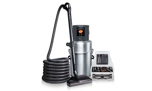 A central vacuum cleaner system with a silver metal canister, a long coiled black hose, an attachment, and tool set.