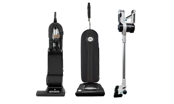 Three different vacuum cleaners: two black upright models and one white cordless stick vacuum on a white background.