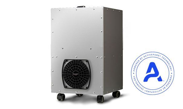 A silver, industrial-style air purifier on wheels with a prominent black fan, featuring an A-shaped blue circular logo.