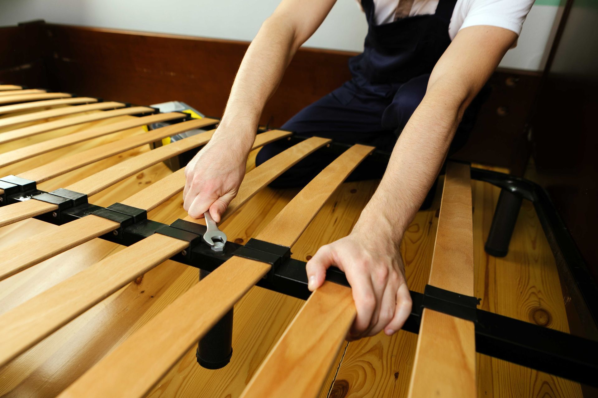 Person playing a wooden xylophone with mallets in a classroom setting