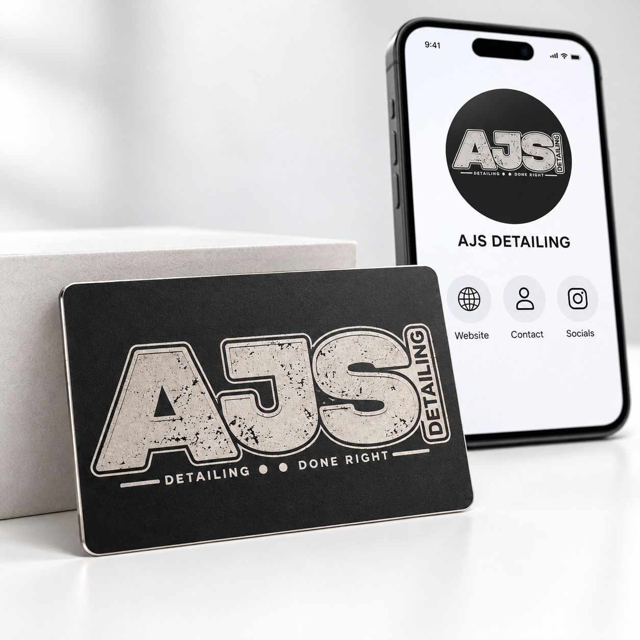 AJS Detailing digital business card beside a phone showing website, contact and social profile icons