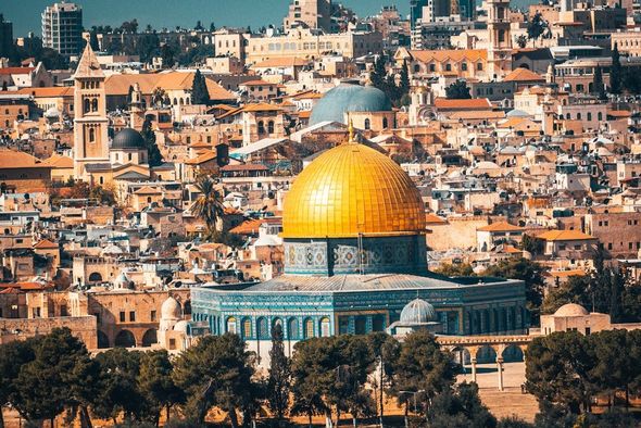 Jerusalem skyline with the golden Dome of the Rock above clustered stone buildings