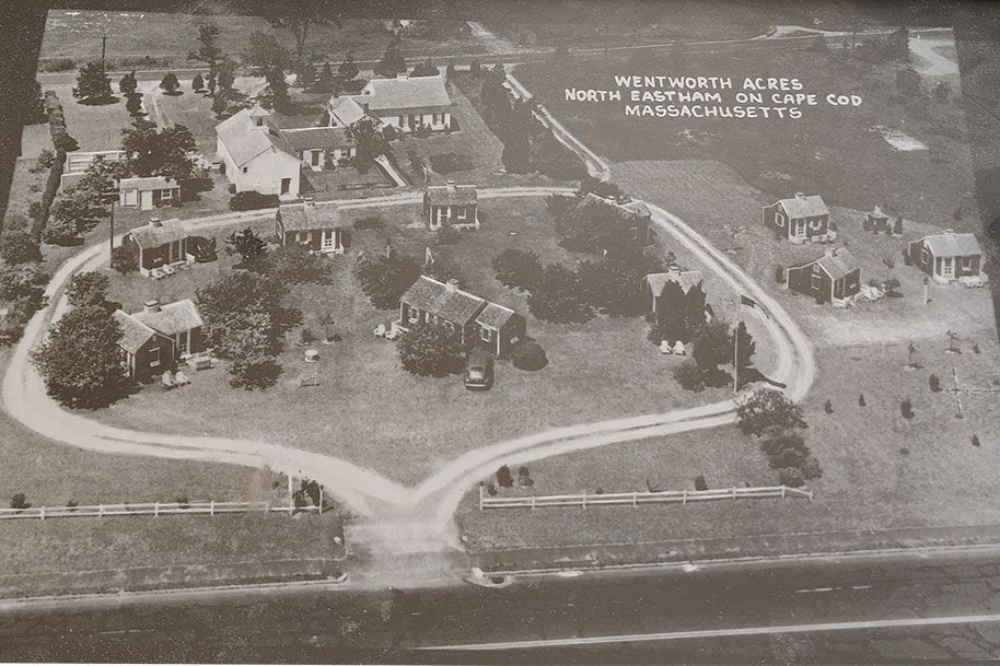 Aerial view of Wentworth Acres in North Eastham, Cape Cod, featuring several small cottages around a central driveway.