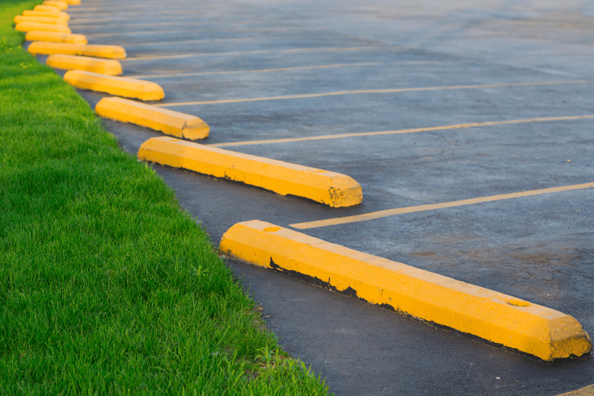 worker leveling fresh asphalt on a road construction