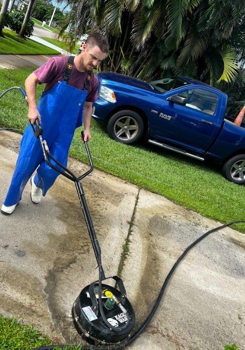 Man Pressure Washing Driveway