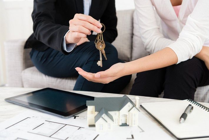 Woman Handing Over Keys — City Artesia, CA — Sapphire Escrow, Inc Woman Handing Over Keys — City Artesia, CA — Sapphire Escrow, Inc