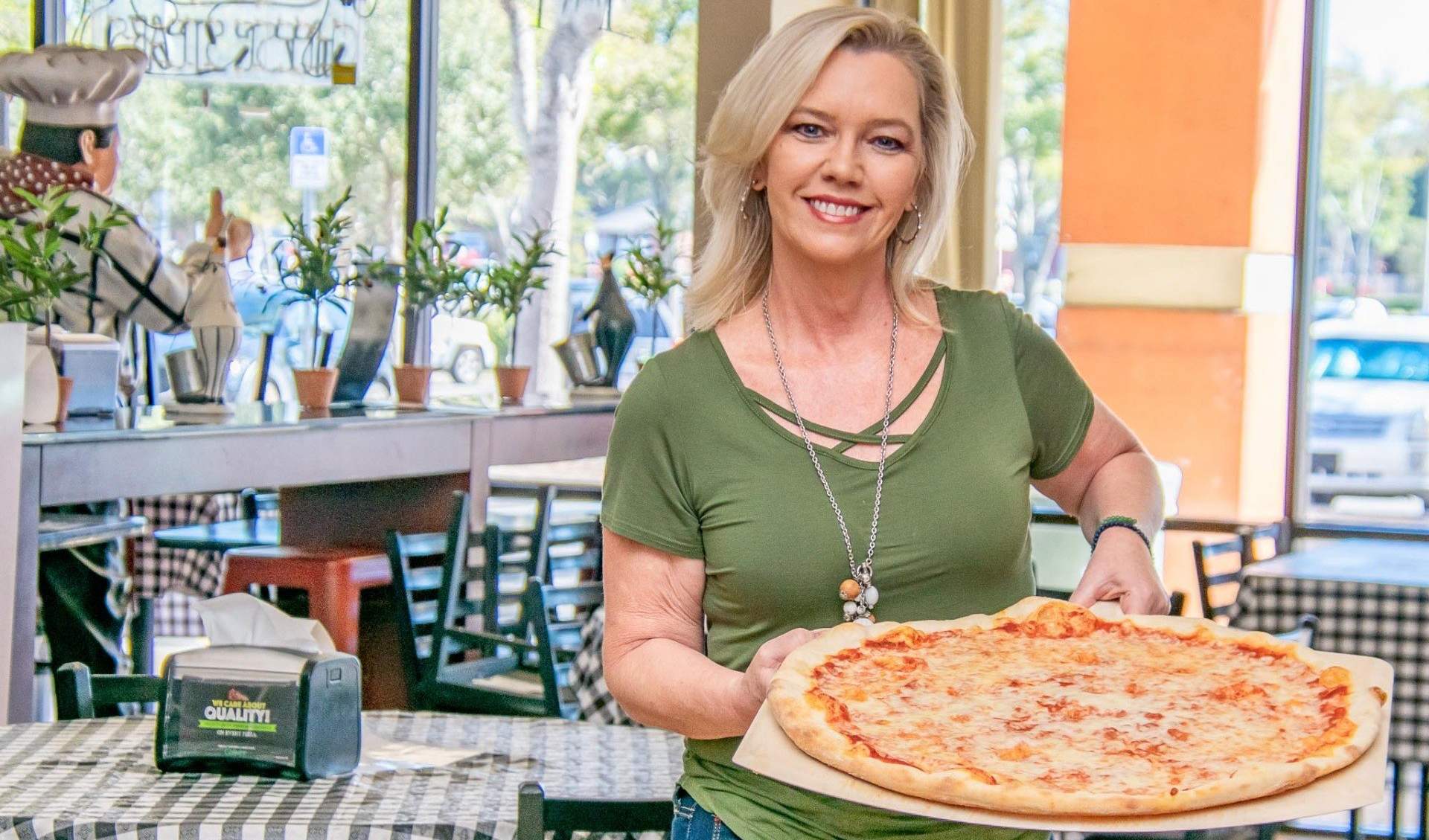 Extra Large Cheese Pizza held by Kristy at Napoli Italian Pizzeria in Orlando FL on Semoran blvd
