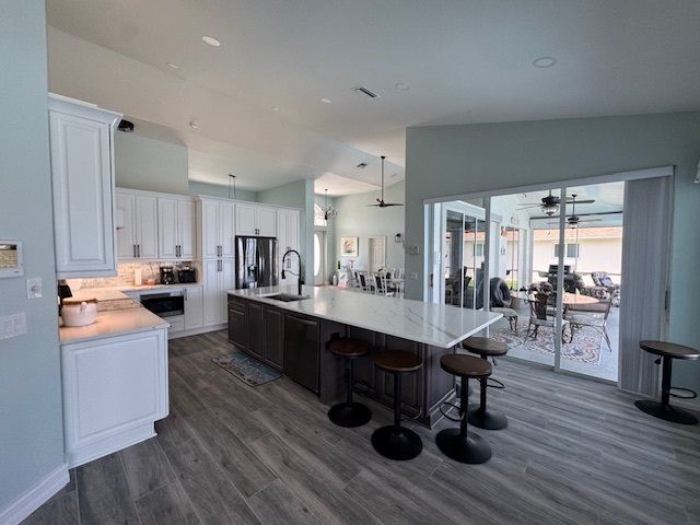 Modern kitchen with a large island, white cabinets, and sliding glass doors.