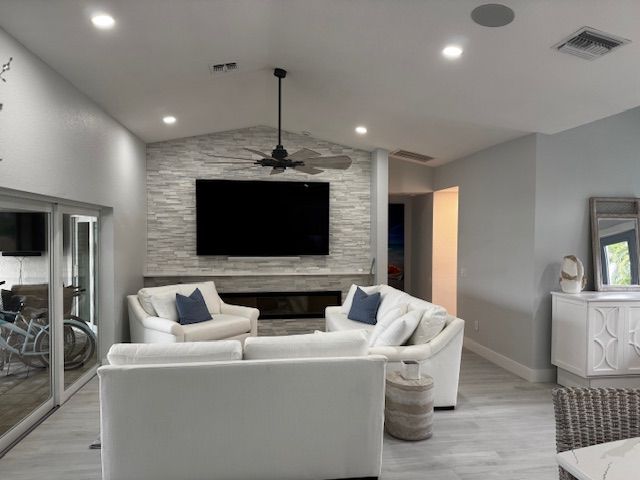 TV above a unique wood console against a blue wall; art and coral decor.