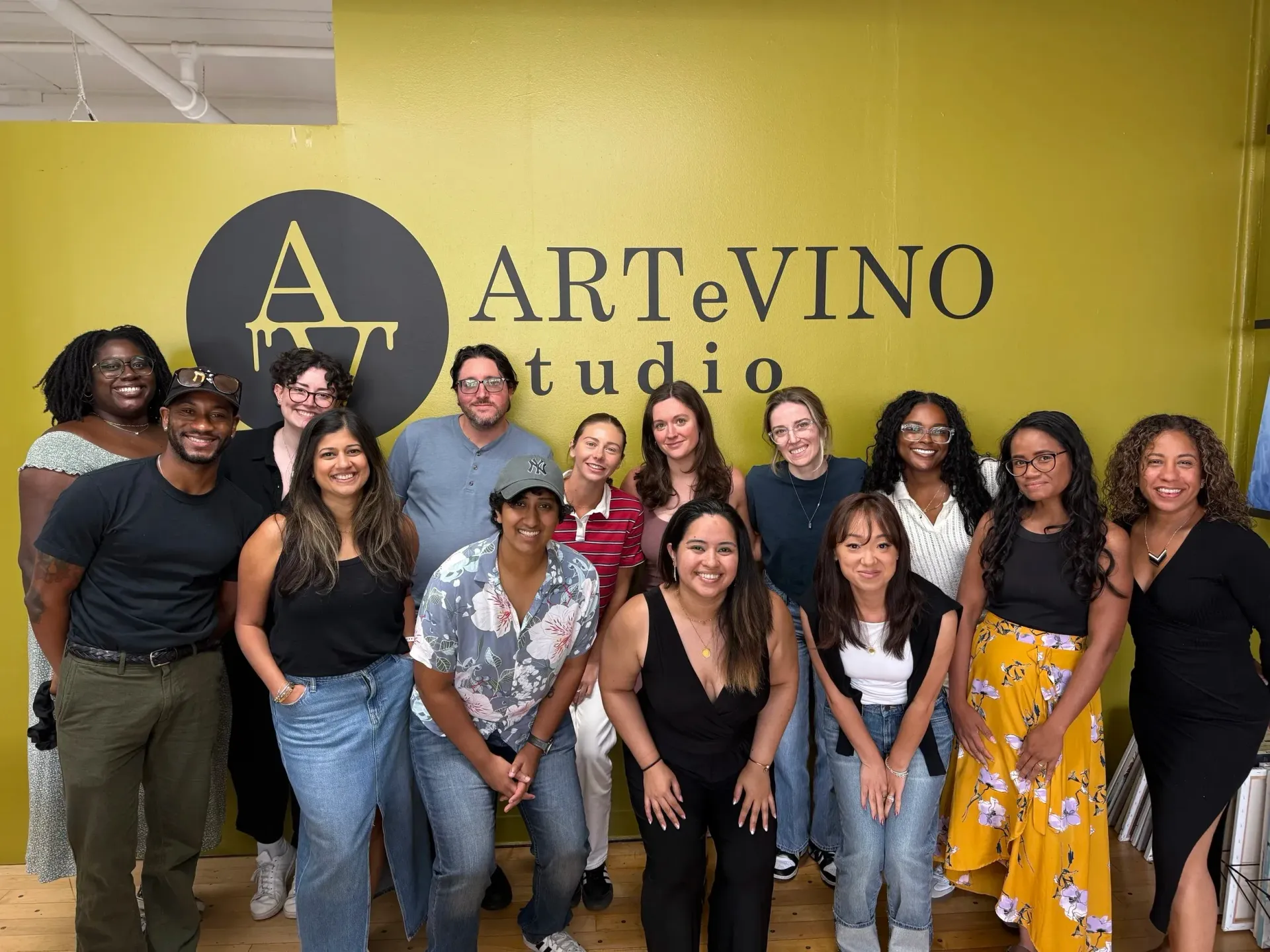 Group of people pose in front of a studio sign that says 
