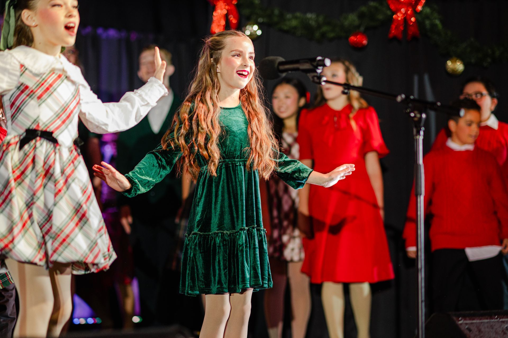 Children's Musical Theatre South Bay California Kids Theater Children performing onstage holiday, singing into a microphone.