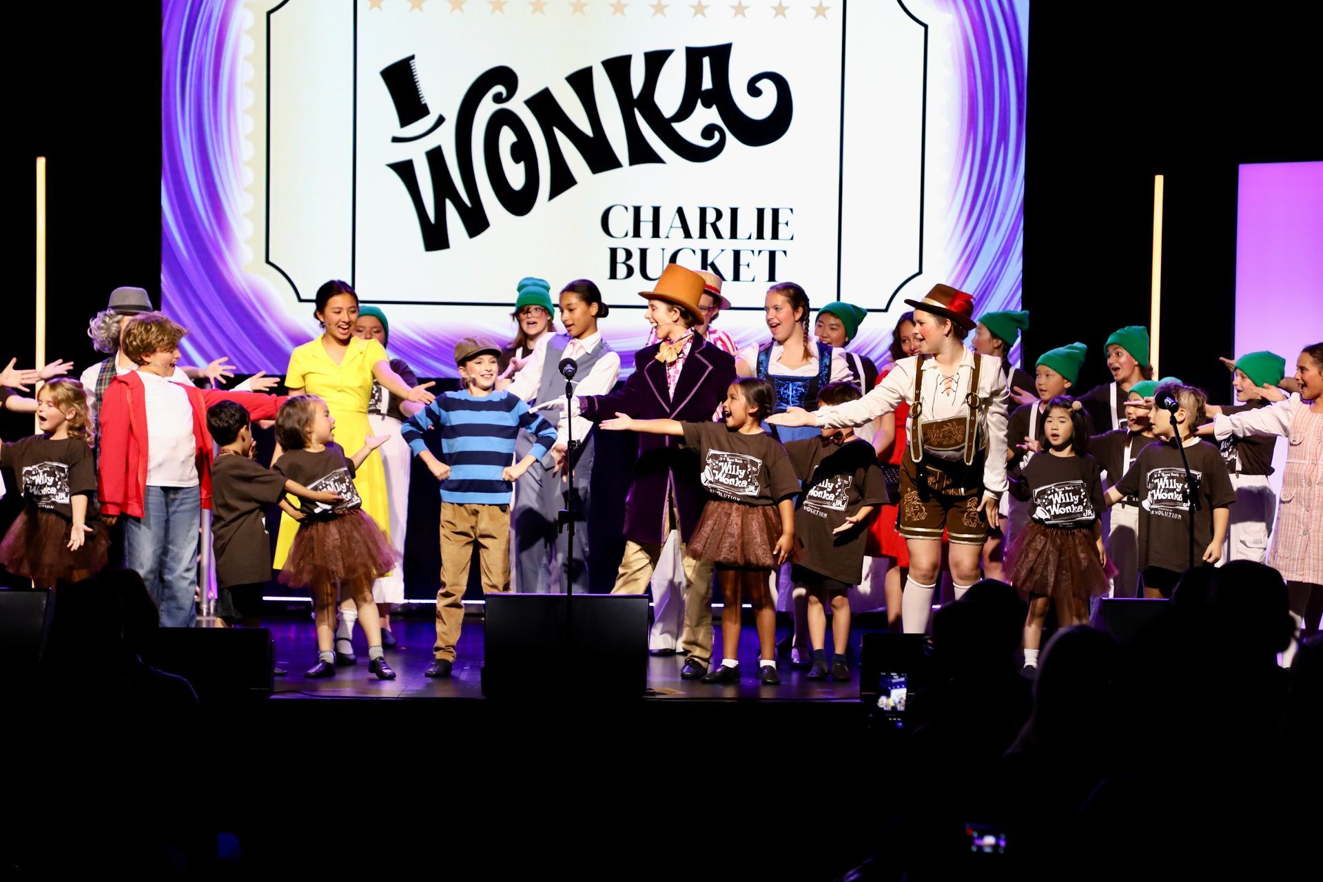 Children in costume onstage during a Wonka Jr. theater performance
