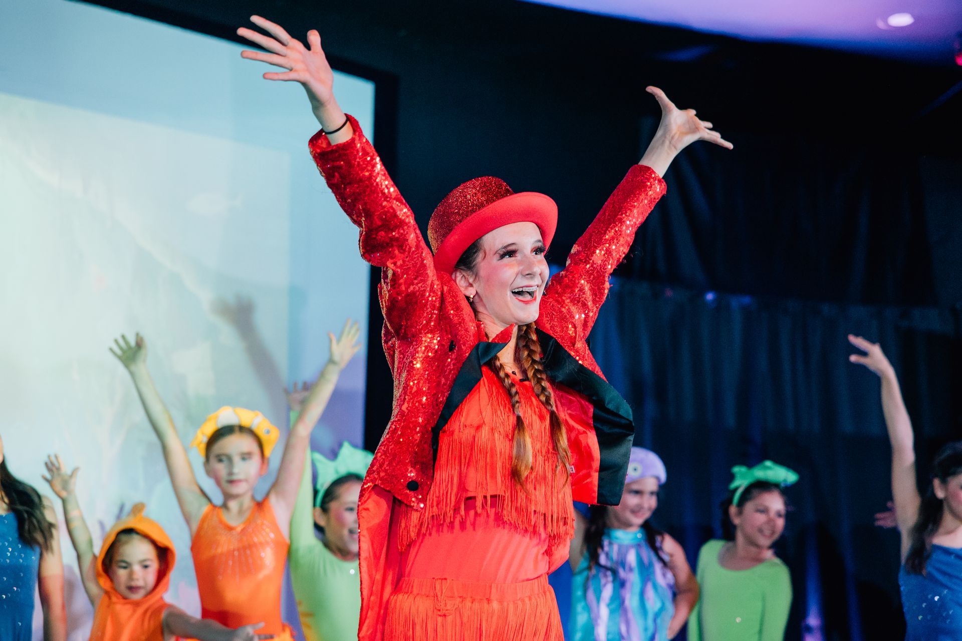 Dancers in colorful costumes performing on stage for the  Little Mermaid stage production.