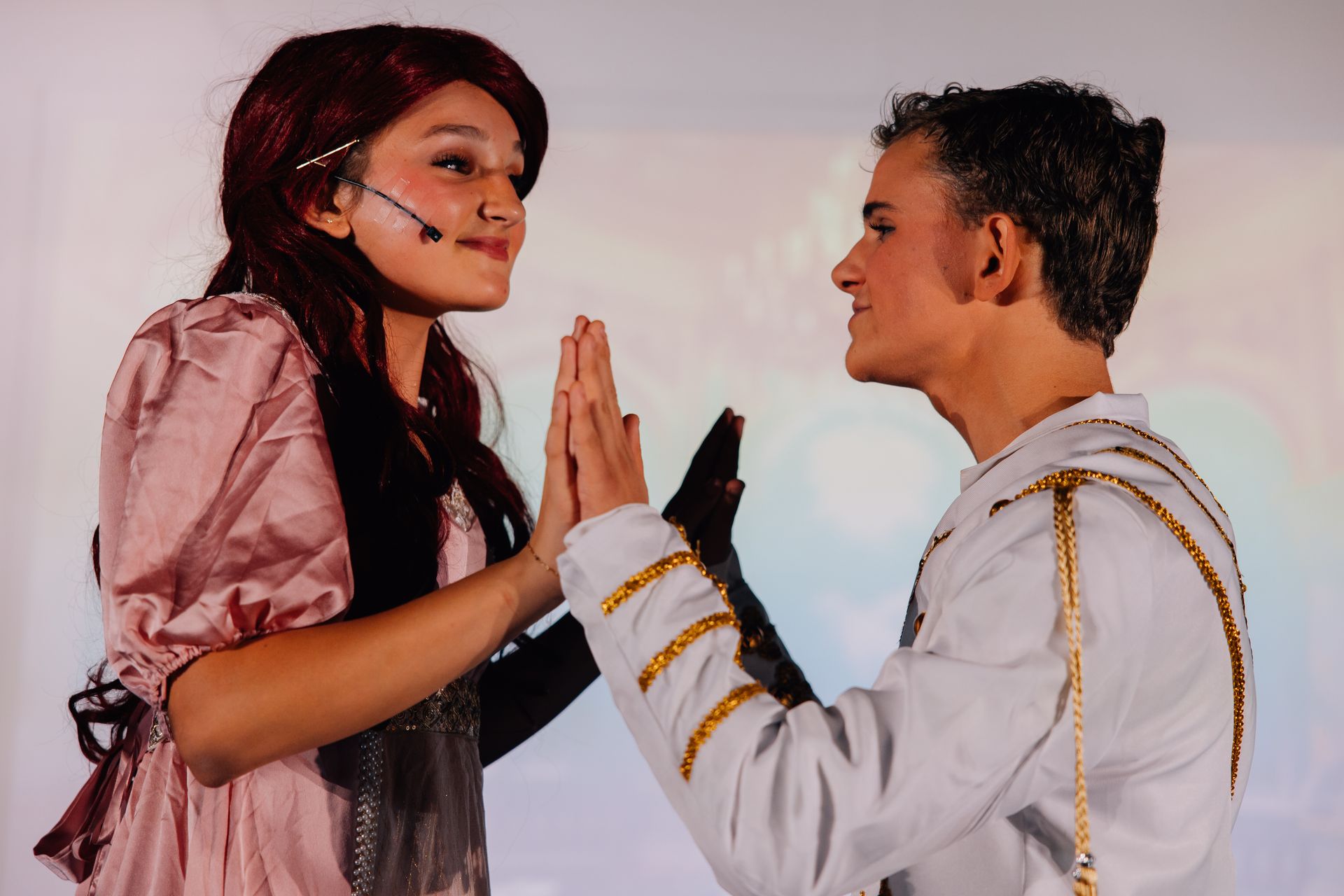 Two child actors, wearing stage-like costumes for the  Little Mermaid stage production.