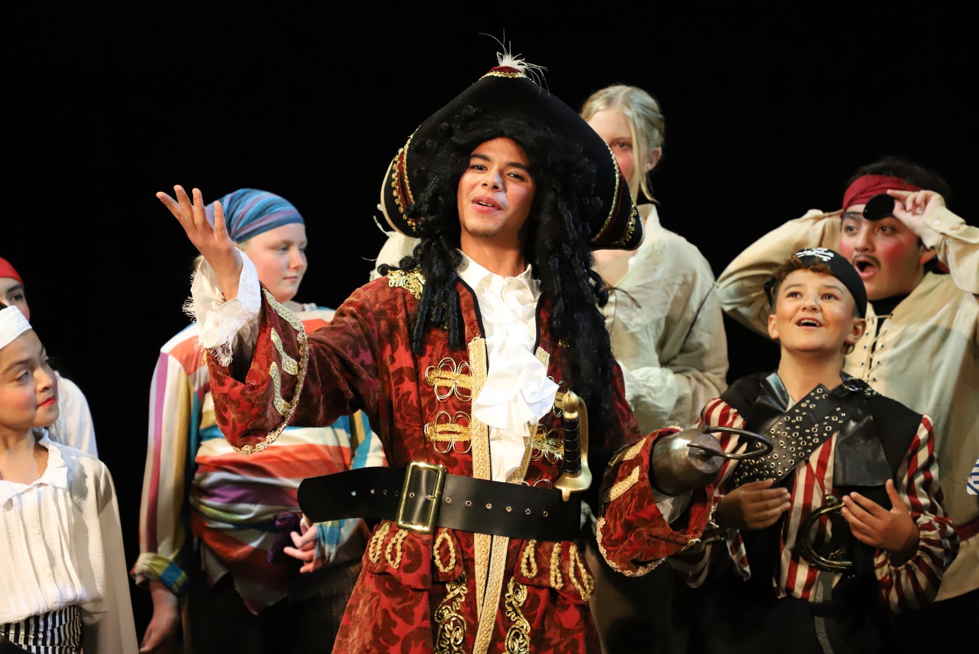 A group of people dressed in pirate costumes on a stage