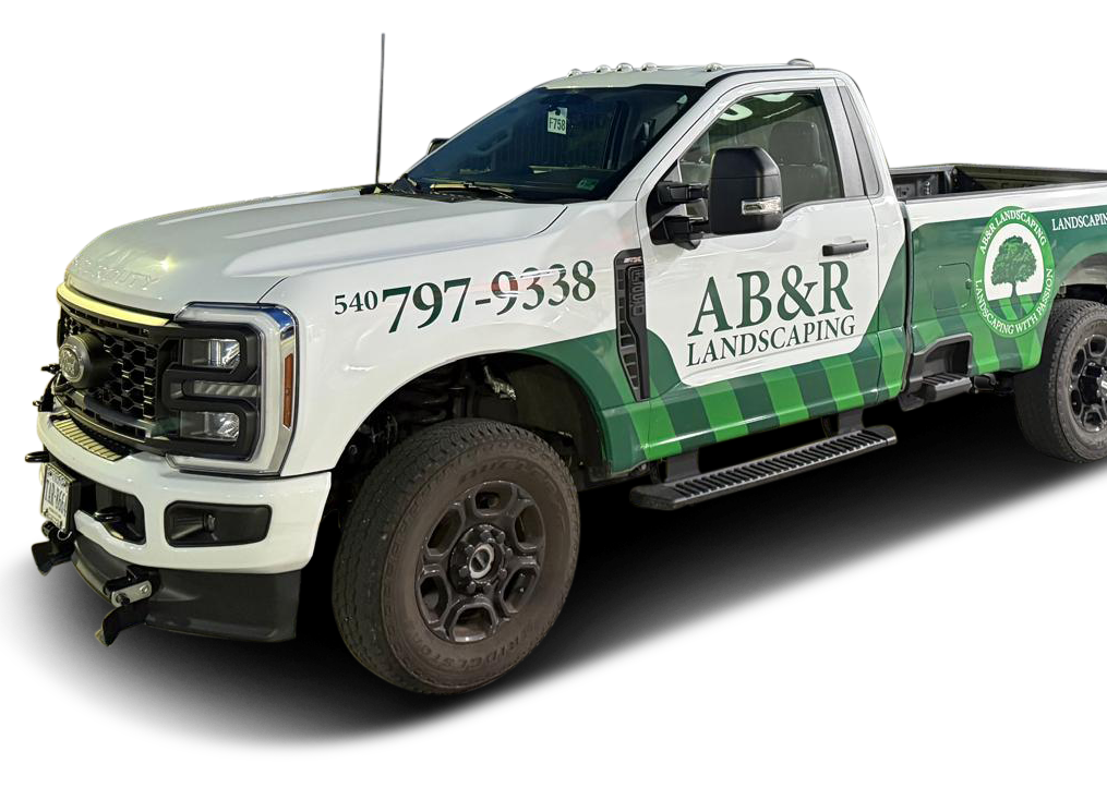 White and green AB&R work truck with company logo and phone number on the side
