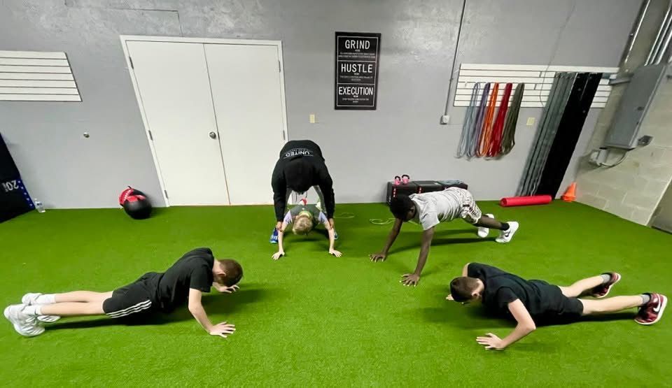 A group of men are doing push ups in a gym.