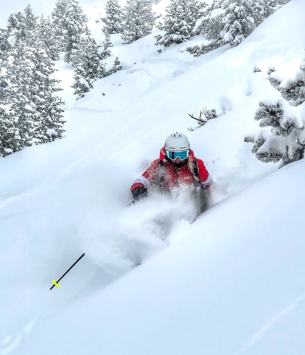 Una persona está esquiando por una pendiente cubierta de nieve.