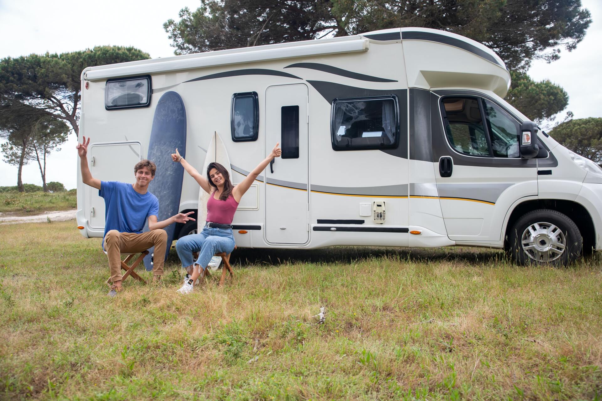 couple sitting outside the rv
