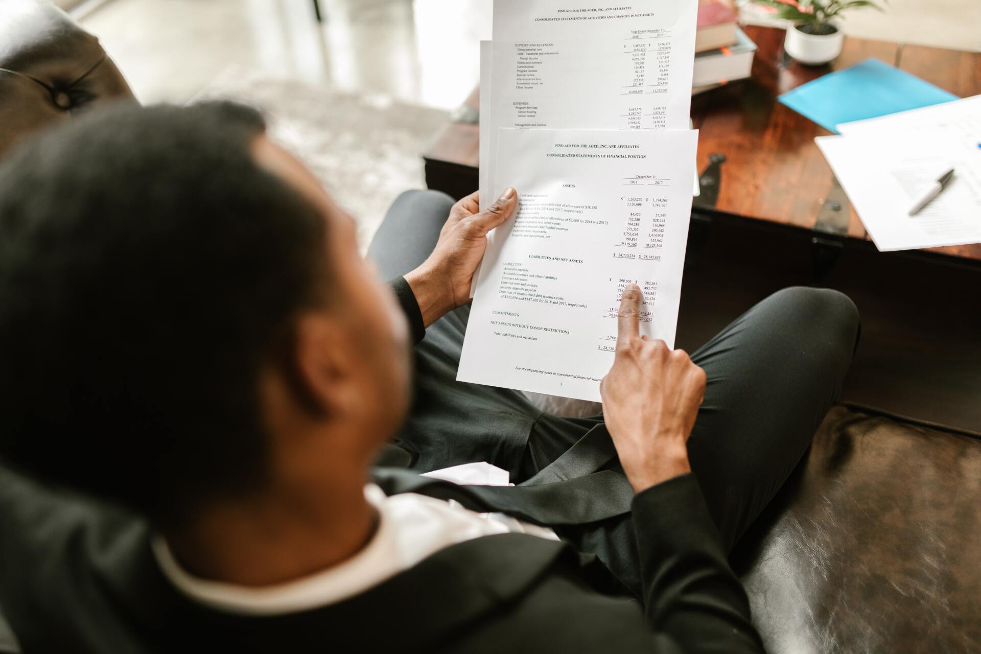Man reviewing a policy on papers