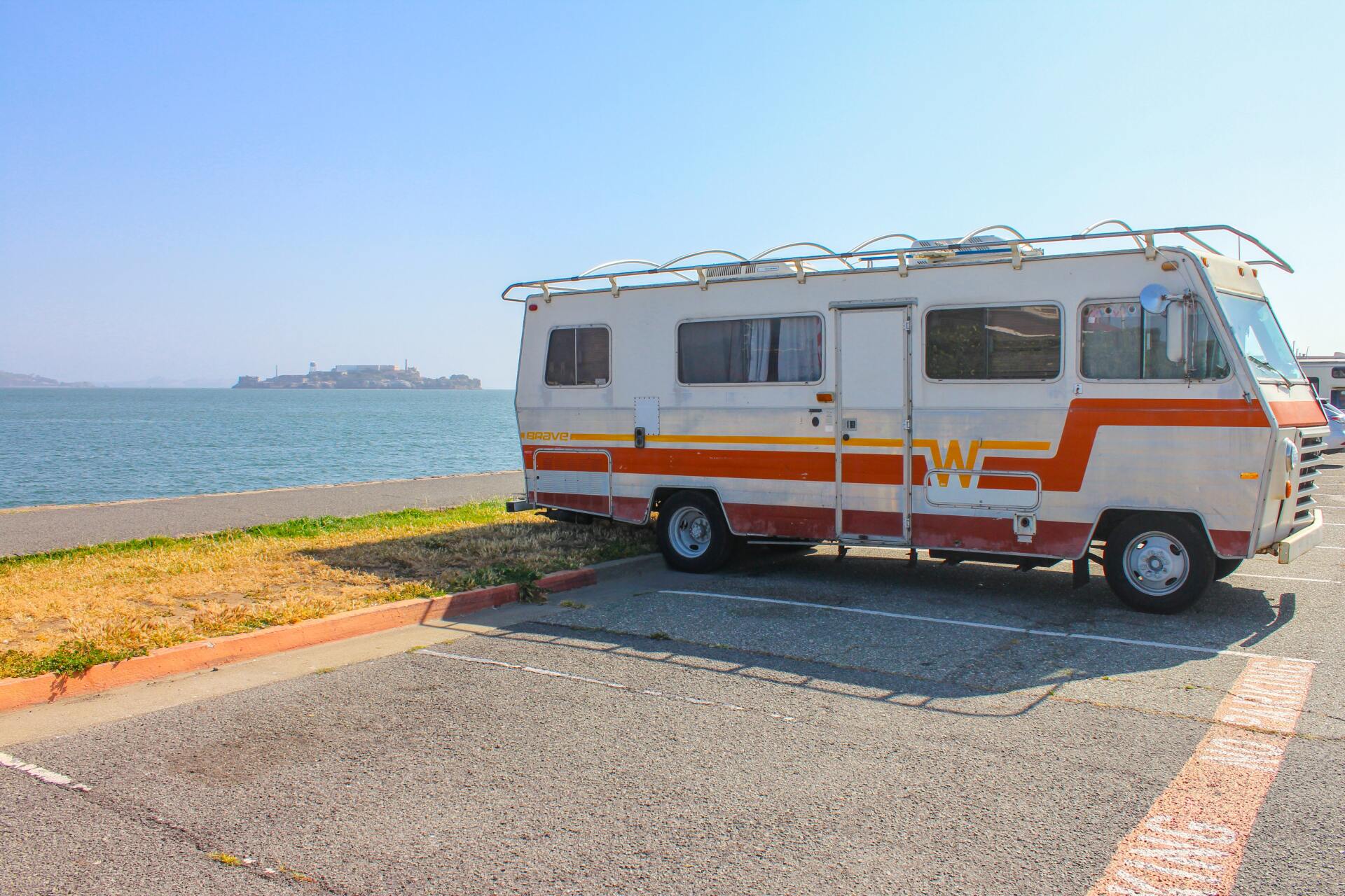 RV van parked alongside ocean