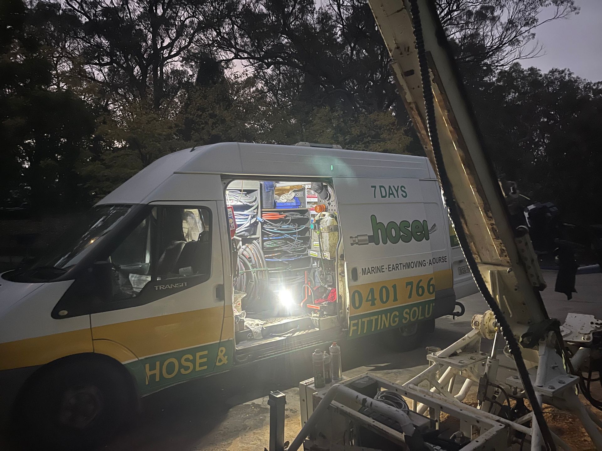 A Man Wearing Orange Gloves Is Working On A Machine With A Wrench — Hosemobile In Kariong, NSW