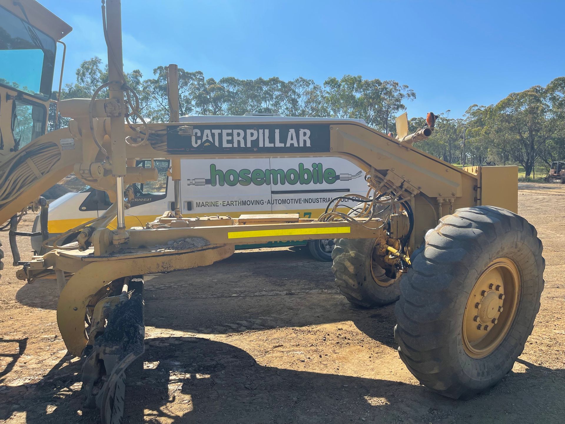 A caterpillar tractor is parked in a dirt field — Hosemobile In Kariong, NSW