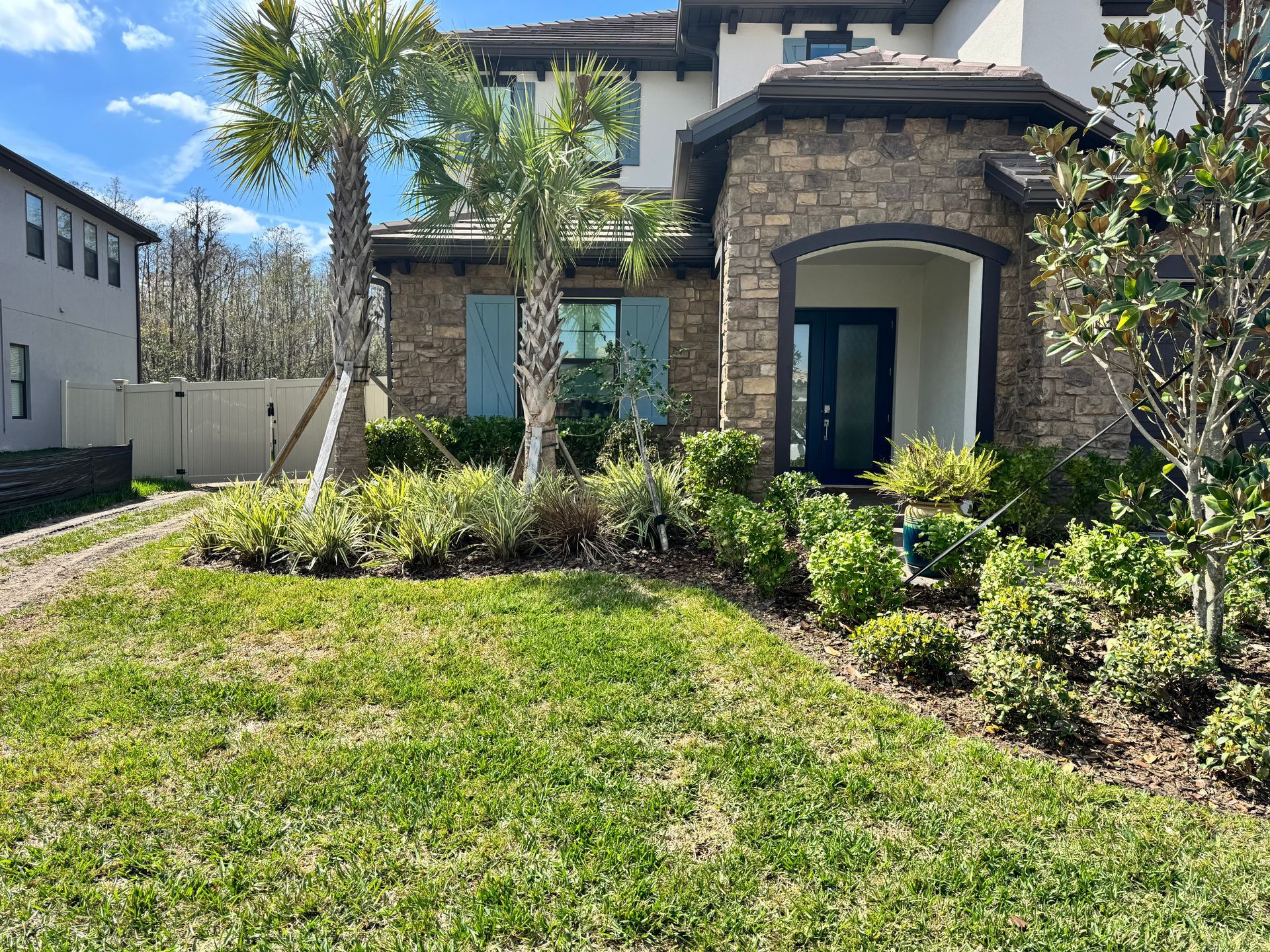 A large house with a lush green lawn in front of it.