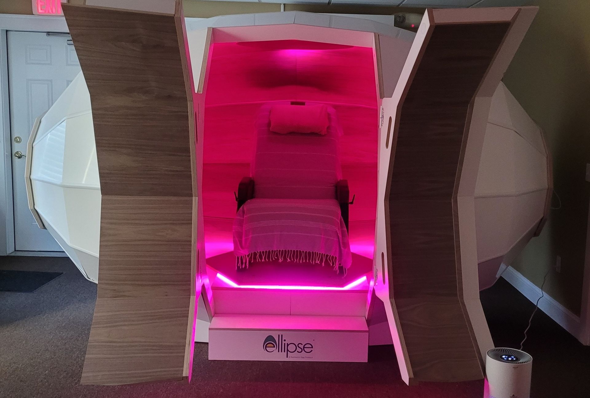 A cardboard box with a bed inside of it.