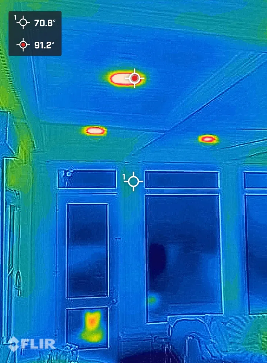 Thermal image of a room showing heat signatures