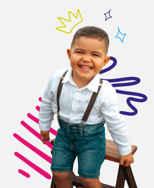 Smiling child in suspenders and denim shorts, standing on a stool. Decorated with doodles.