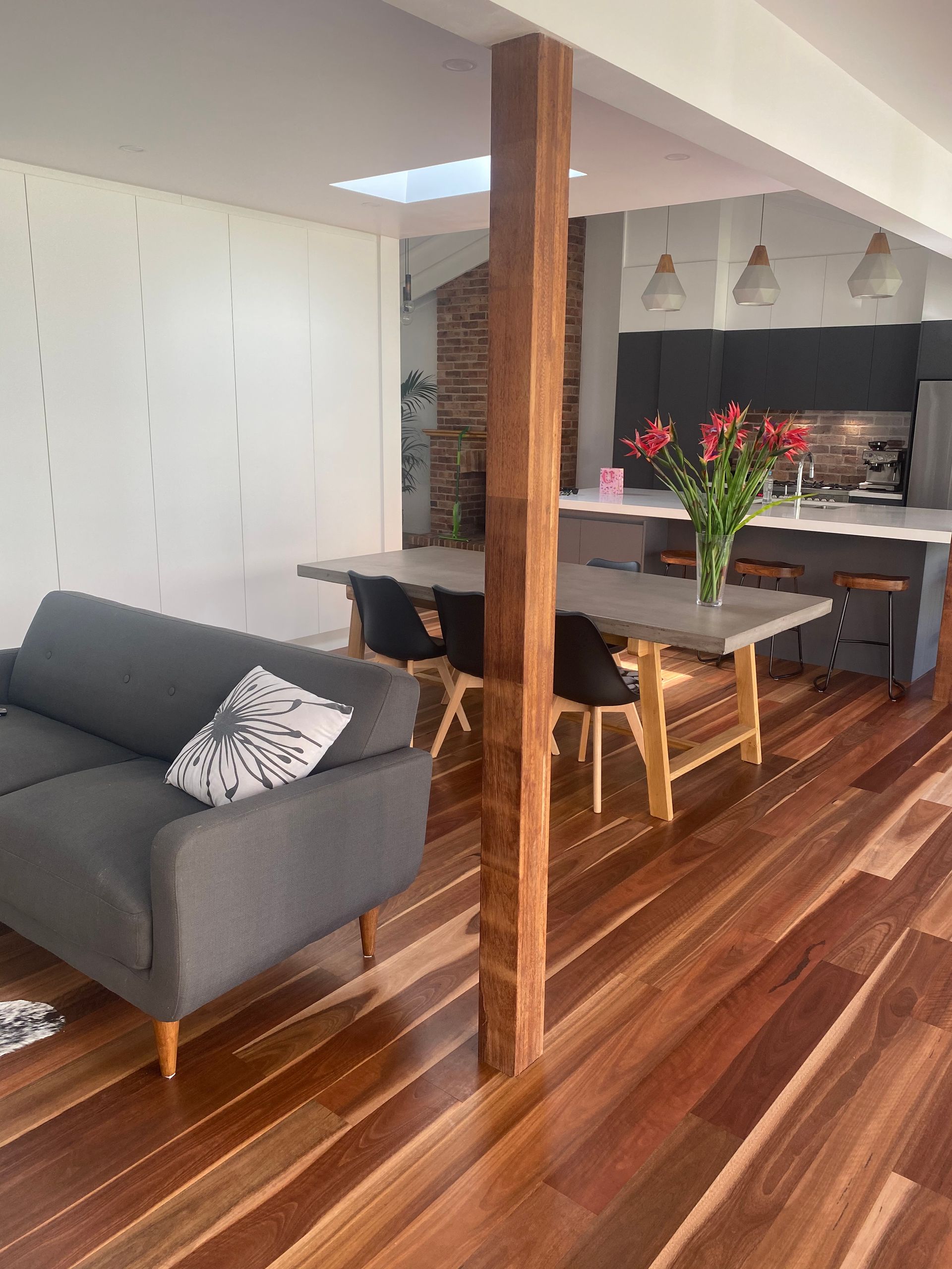 Wood floor with sofa chair dining table with flowers on it