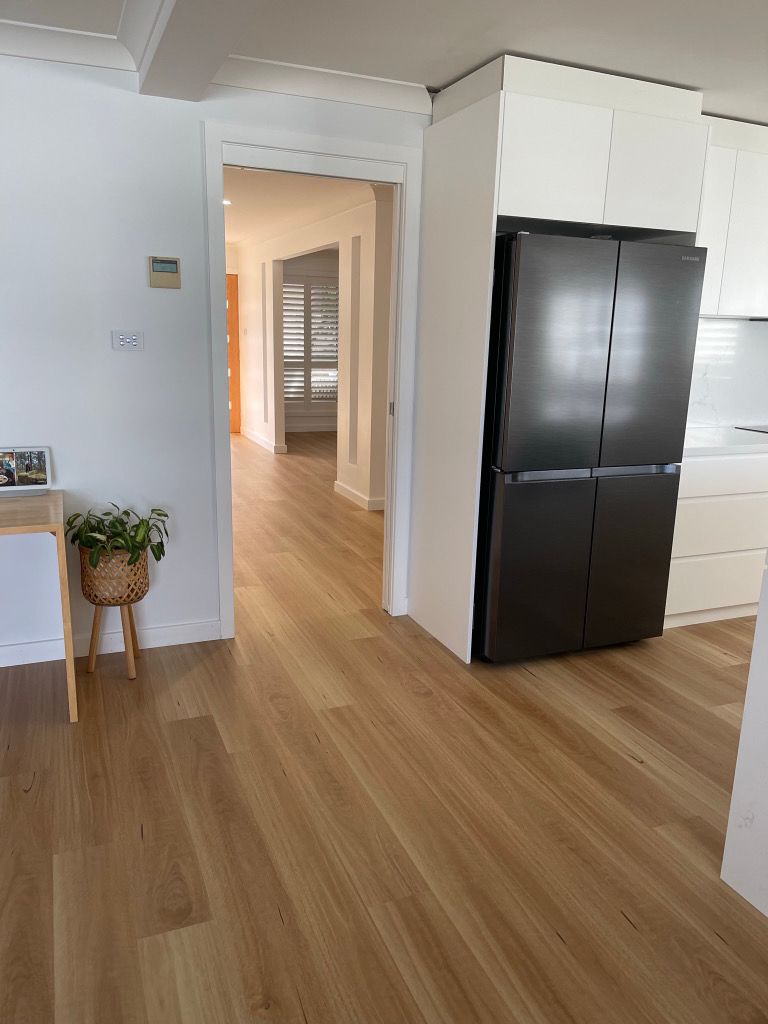 A kitchen with hardwood floors