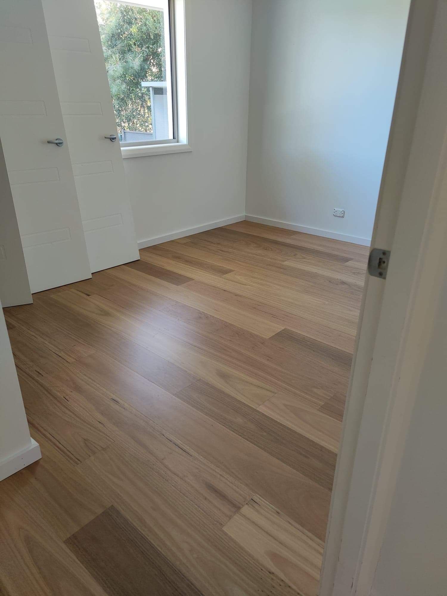Empty room with shiny wooden floor