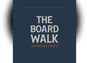 The Board Walk restaurant logo on a dark blue square with gold border and text, “Waterside Dining”
