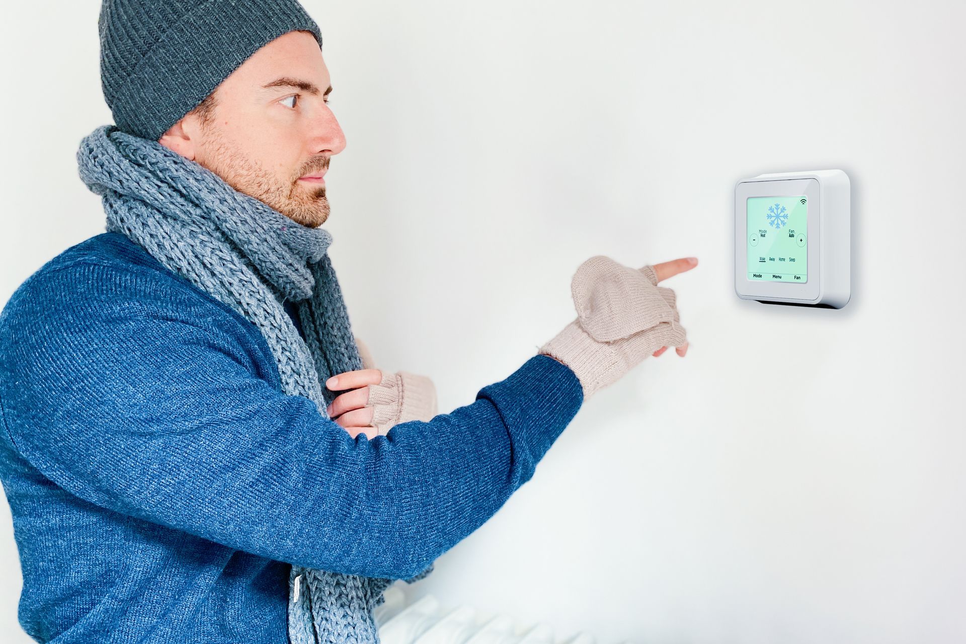 HVAC technician using gauges to check an air conditioning unit.