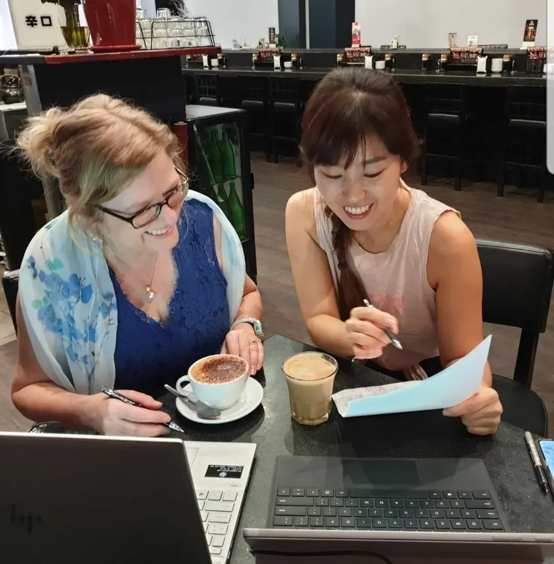 Two woman working together at a coffee shop — Adding Value CFO Pty Ltd in Larrakeyah, NT